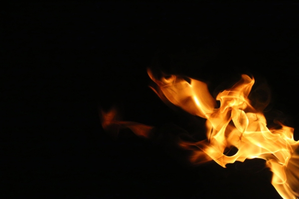 yellow flame on black background depicting change in furnace flame color