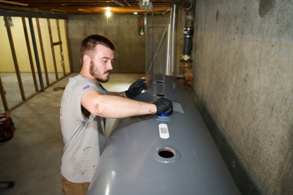 Miller Oil Company technician oil tank inspection during summer