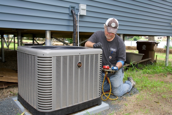 Miller Oil Company professional HVAC technician attending to AC outdoor unit