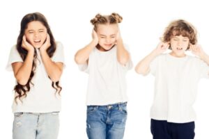 kids covering ears depicting Air Conditioner making Loud Noise When Starting