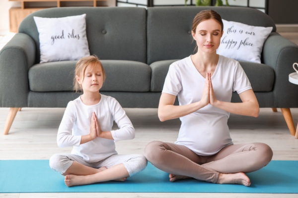 pregnant mom with your daughter meditating indoors depicting good indoor air quality