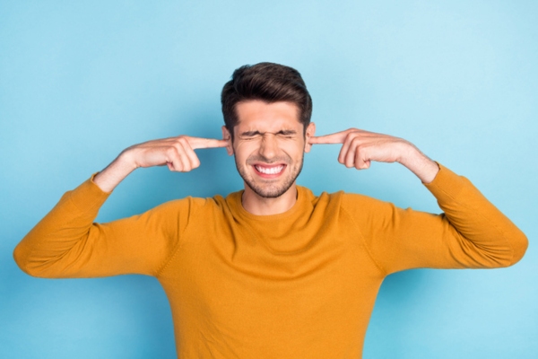 man covering ears and closing eyes depicting ignoring routine maintenance