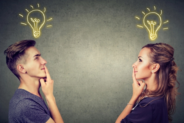 man and woman looking at each other with eureka lightbulb on top of head depiting understanding evaporator and condenser coil