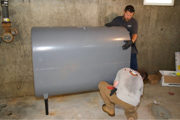 Miller Oil Company staff installing heating oil tank for a client