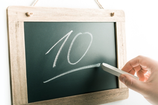 Number 10 Handwritten With Chalk On A Blackboard depicting 10 tips to lower oil heating costs