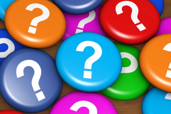 colorful button pins with question marks depicting FAQs