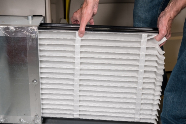 homeowner checking the status of furnace filter