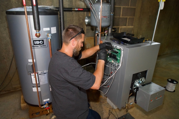 Miller Oil Company HVAC technician attending to a client's heating system