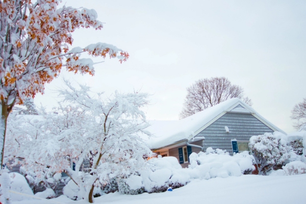 heavy snowfall covering the house and street due to extremely low temperature