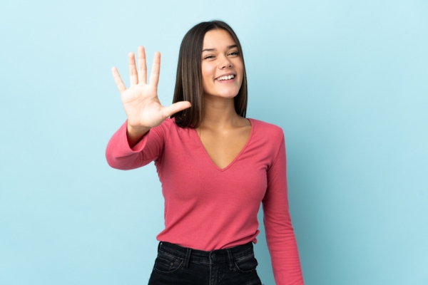 woman holding 5 fingers up depicting 5 common causes of boiler leaks