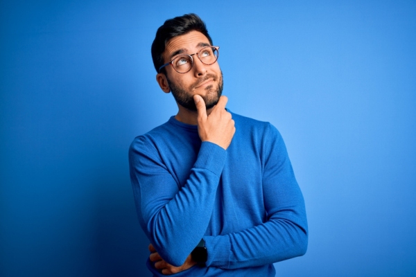 image of a man thinking depicting analysis of forced air and hydronic heating systems